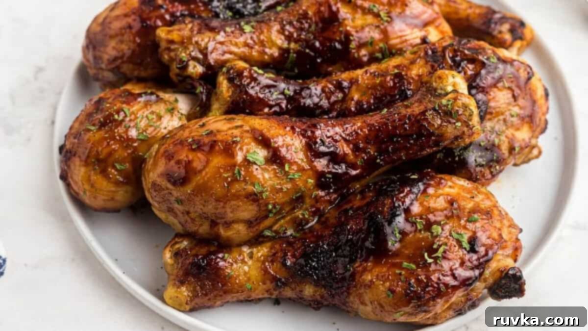 15 Foolproof Air Fryer Recipes 7 Air fried bbq chicken legs on a white plate, ready to serve.