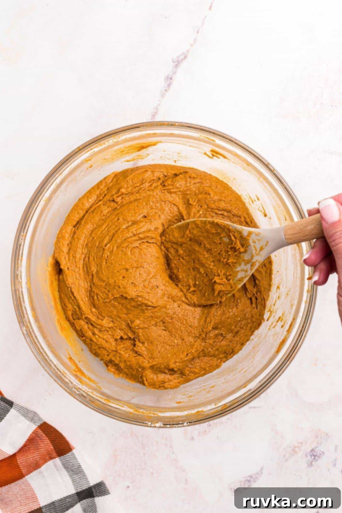 Easy Air Fryer 2 Ingredient Pumpkin Muffins 5 Pumpkin muffin batter combined in a clear glass bowl.