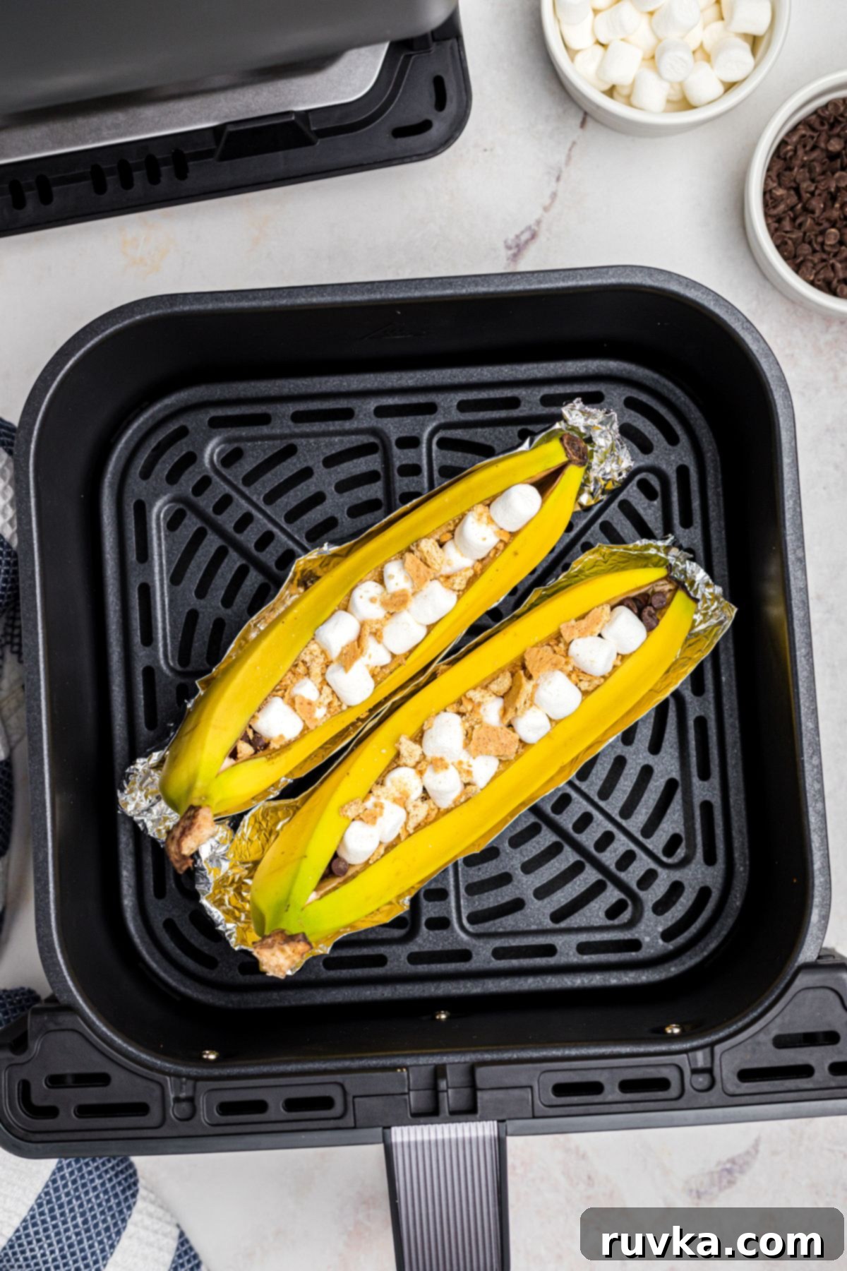 How to Safely Use Foil in Your Air Fryer 4 banana boats on foil in air fryer basket.