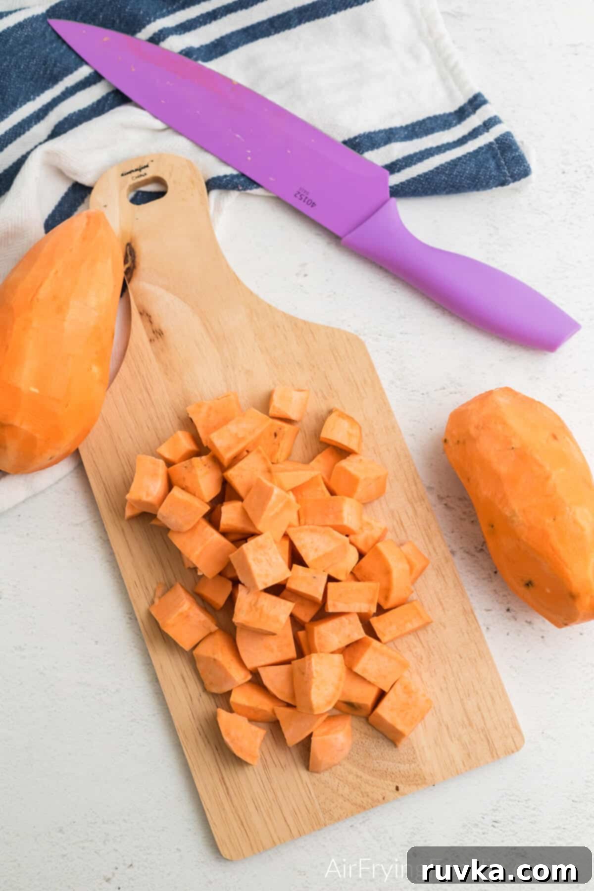Crispy Air-Fried Sweet Potato Cubes 5 Sweet potato cut into small cubes on a cutting board.