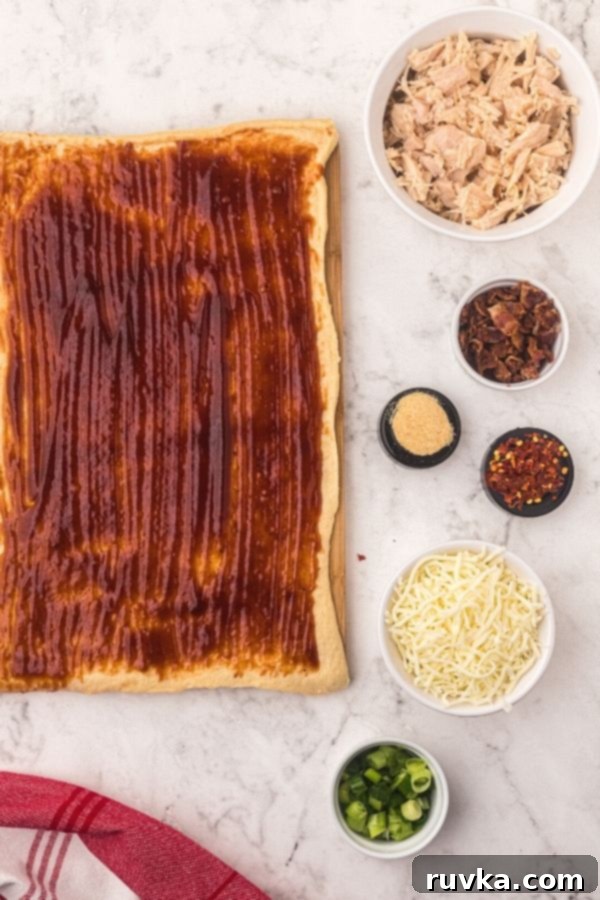 Crispy Air Fryer BBQ Chicken Pizza Rolls 3 Rolled out dough with ingredients in small bowls to make the pizza rolls