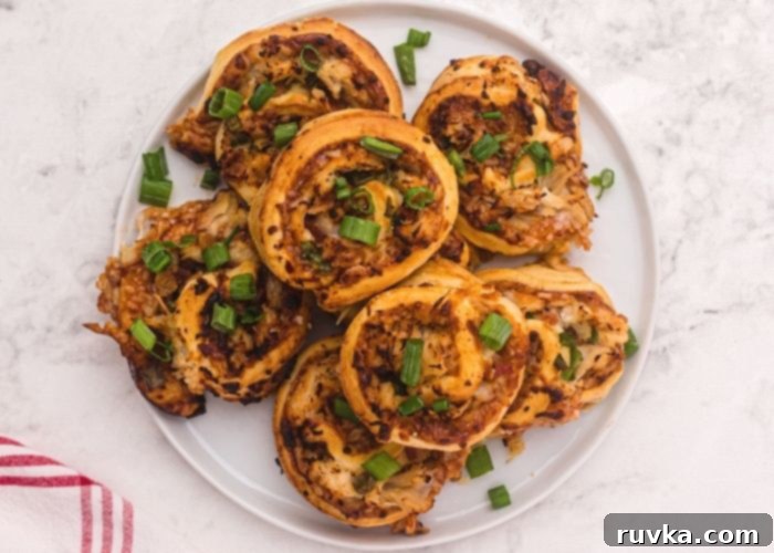 Crispy Air Fryer BBQ Chicken Pizza Rolls 8 Golden filled rolled crust filled with chicken, cheese, BBQ sauce, and topped with chopped green onions.