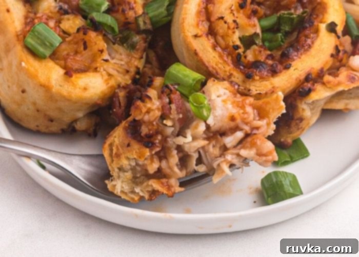 Crispy Air Fryer BBQ Chicken Pizza Rolls 9 Close up bite shot of pizza roll on a fork.