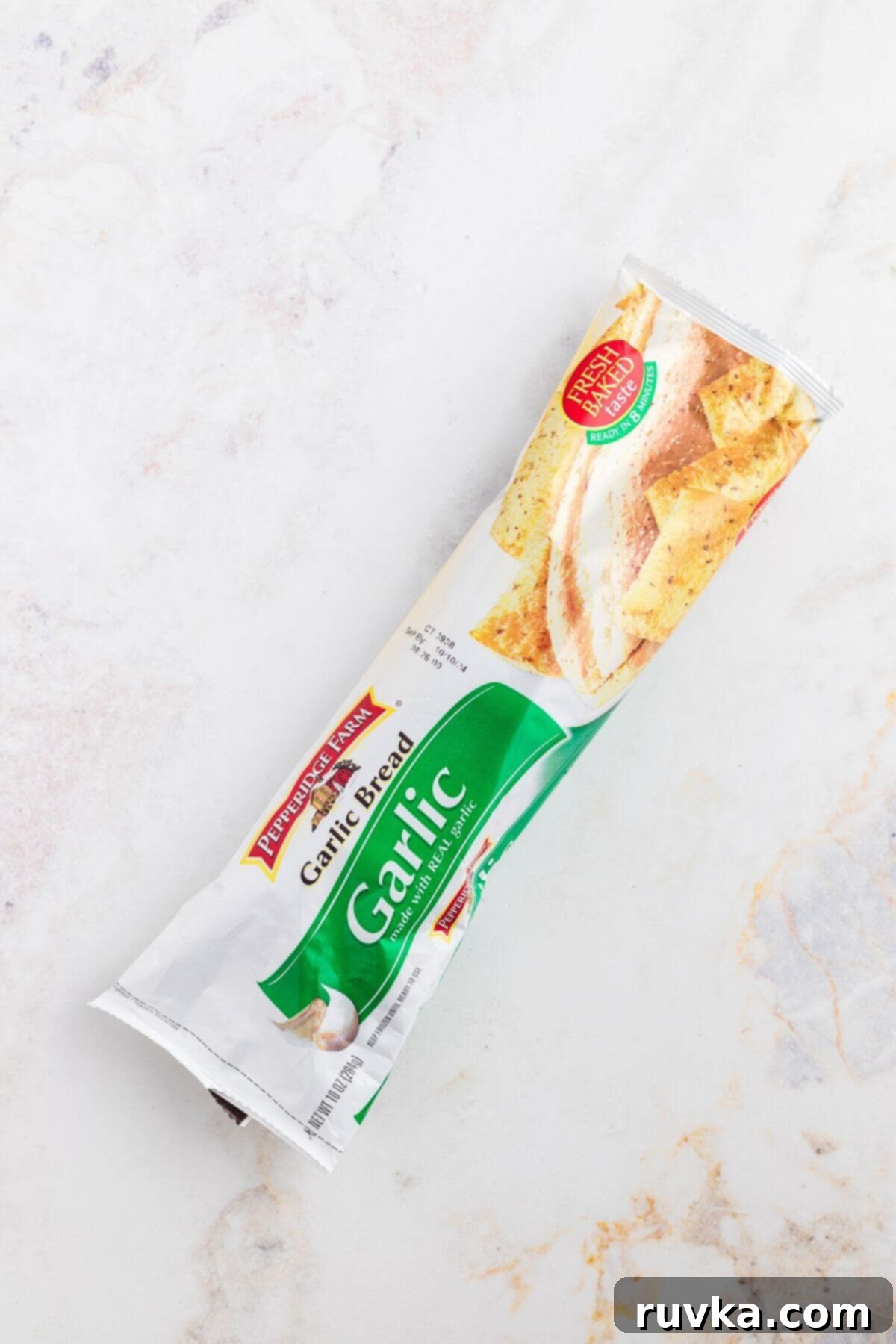 Perfect Air Fryer Frozen Garlic Bread 3 One package of frozen garlic bread on a marble table.