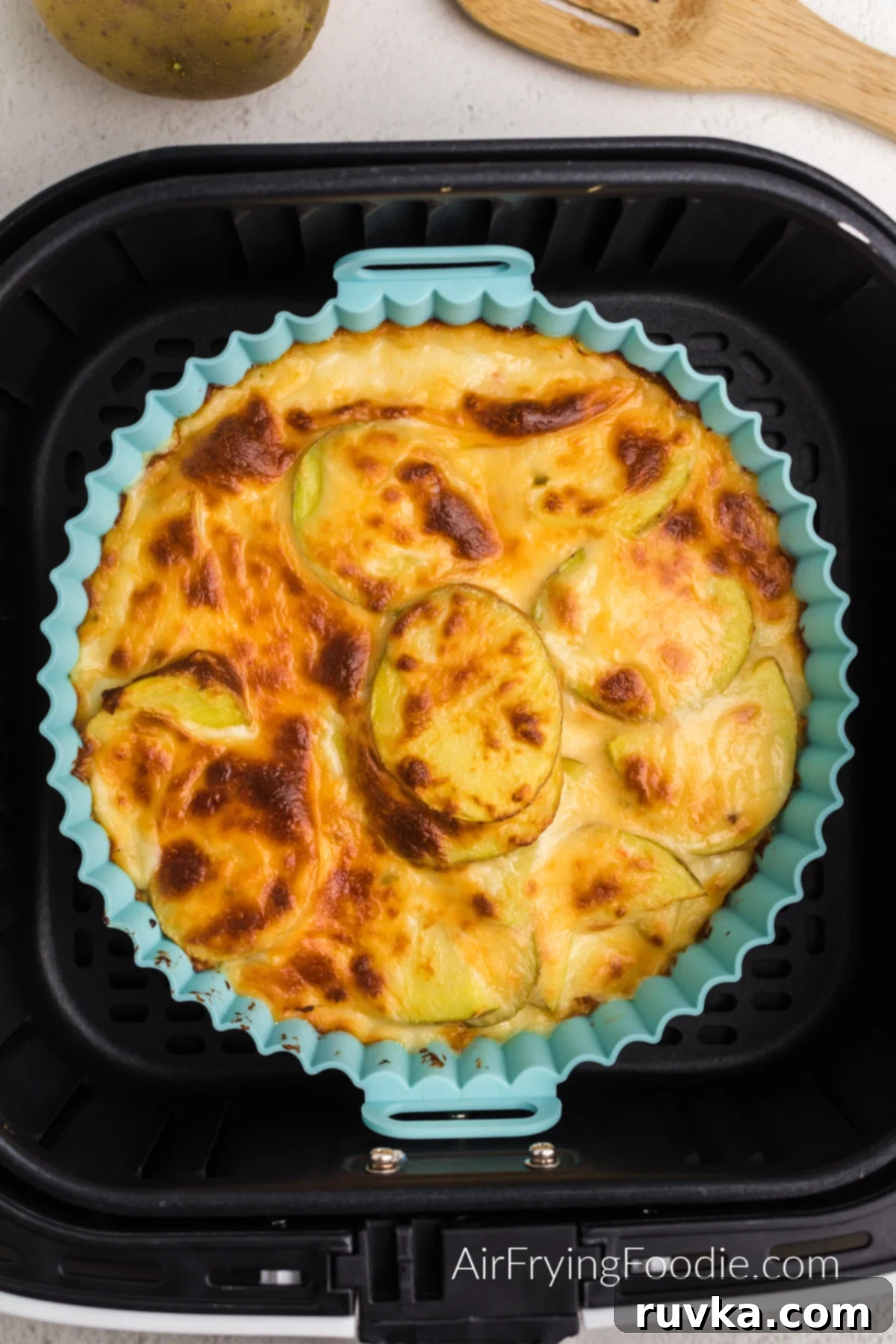Reusable Air Fryer Silicone Baskets 4 Air fryer scalloped potatoes in silicone liner in air fryer basket.