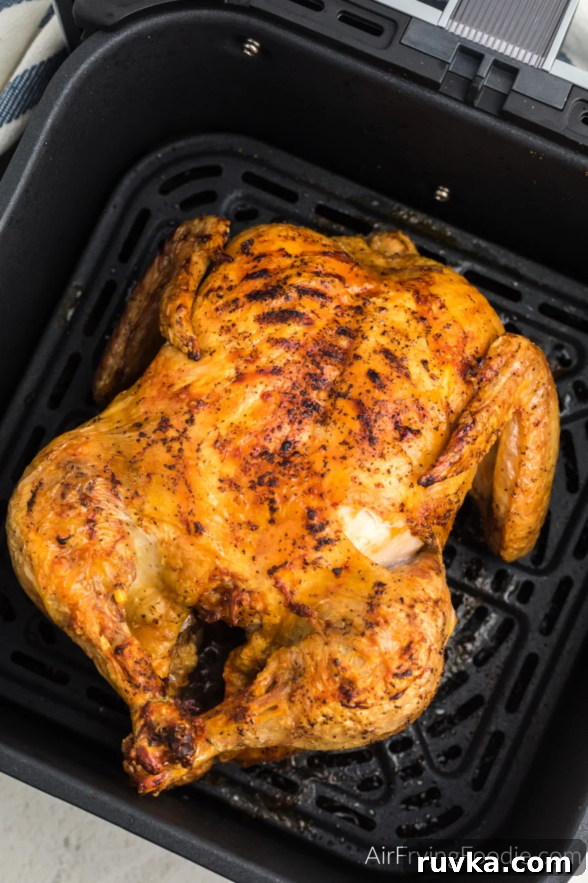Effortless Holiday Feasts: 15 Air Fryer Recipes 7 WHole chicken in the air fryer basket.