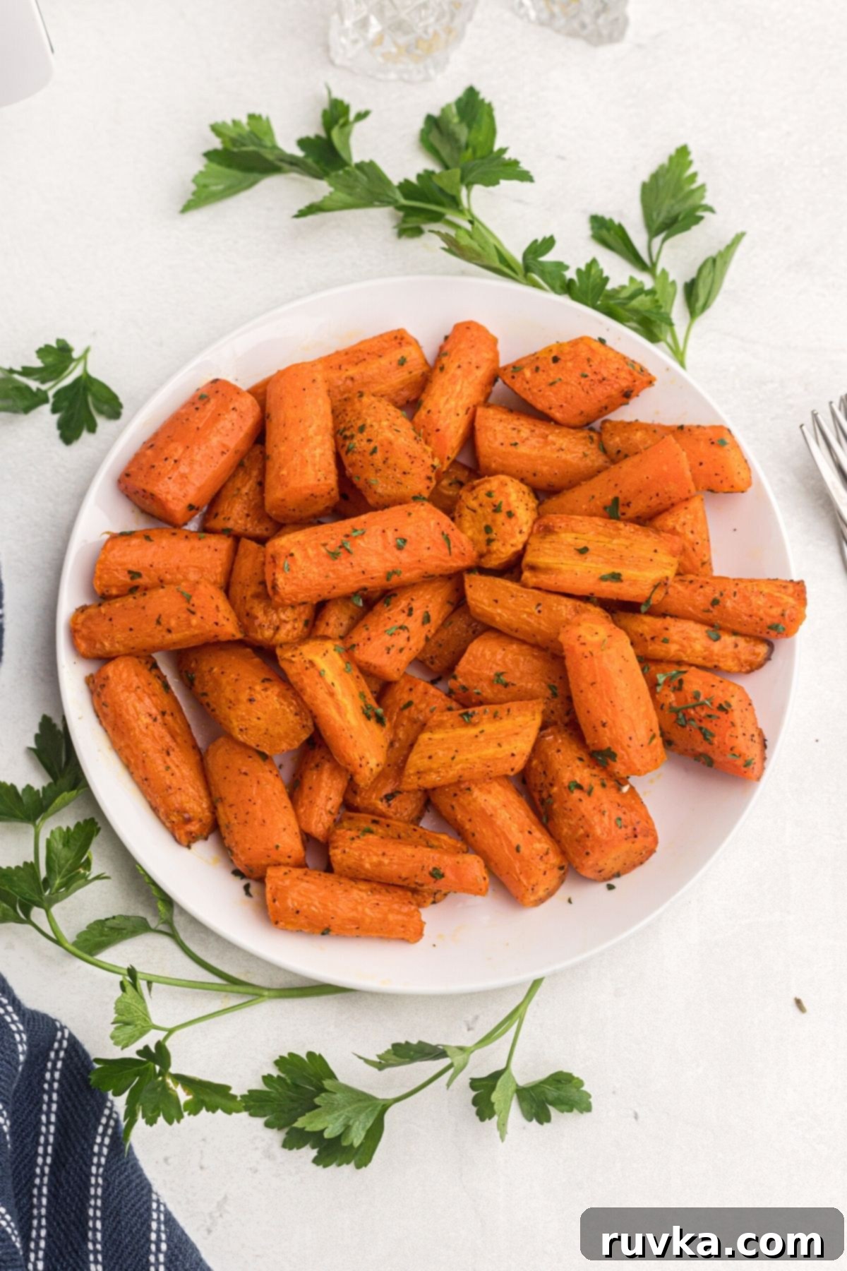 Effortless Holiday Feasts: 15 Air Fryer Recipes 8 Air Fryer Carrots on a white plate ready to eat.