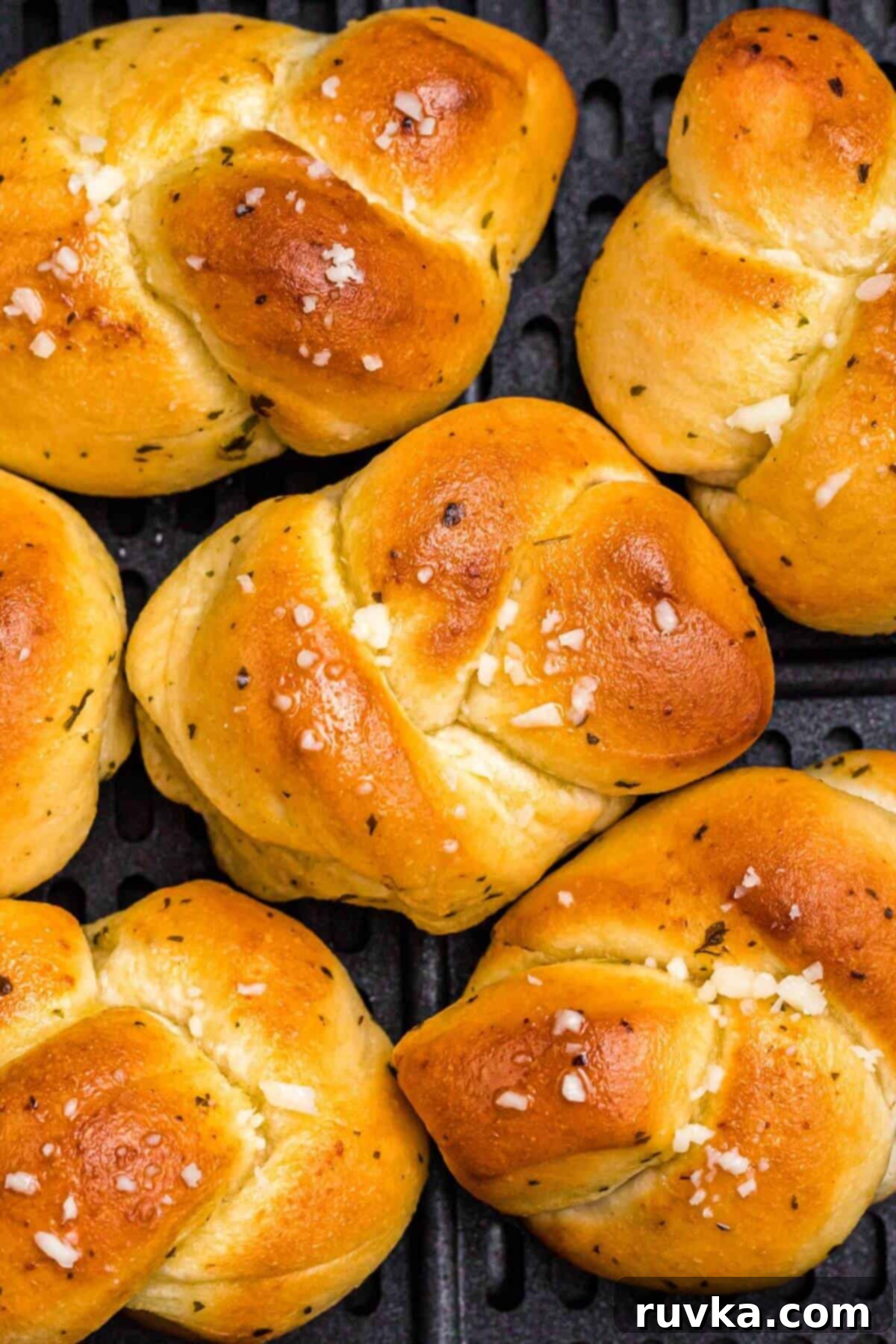 Effortless Holiday Feasts: 15 Air Fryer Recipes 10 Golden garlic knots in the air fryer basket.