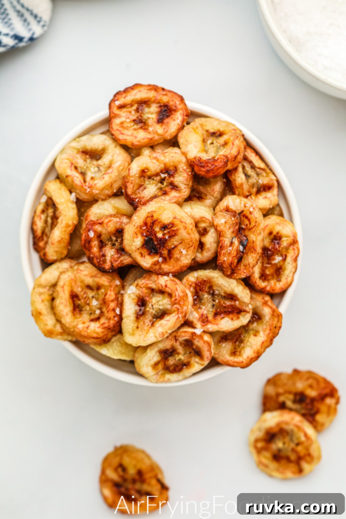 Sizzle into the New Year: 15 Air Fryer Recipes to Revolutionize Your Cooking 15 overhead of banana chips in a bowl.