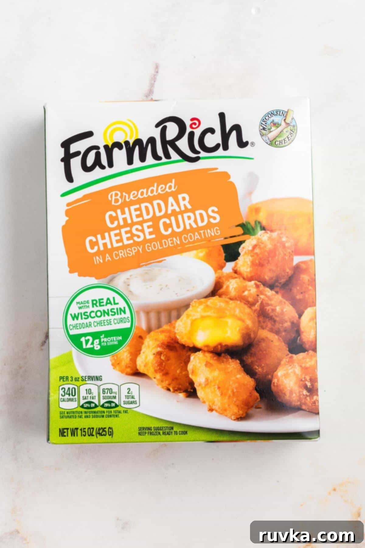 Crispy Air Fryer Frozen Cheese Curds 3 Box of frozen cheese curds on a marble board, ready for the air fryer.