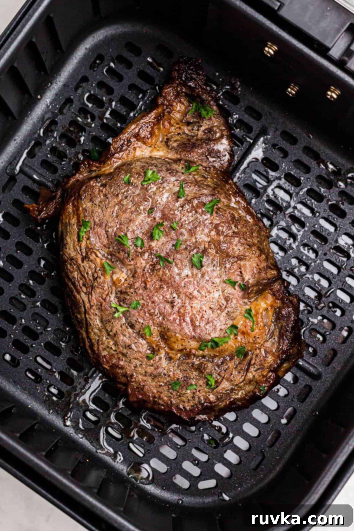 No Thaw Air Fryer Steak Perfection 5 Juicy cooked steak in the air fryer basket.