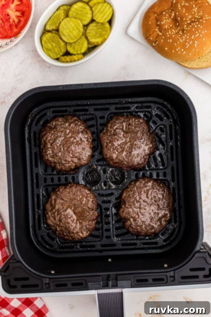Perfect Air Fryer Burgers 5 Four juicy hamburger patties cooked in the air fryer basket.