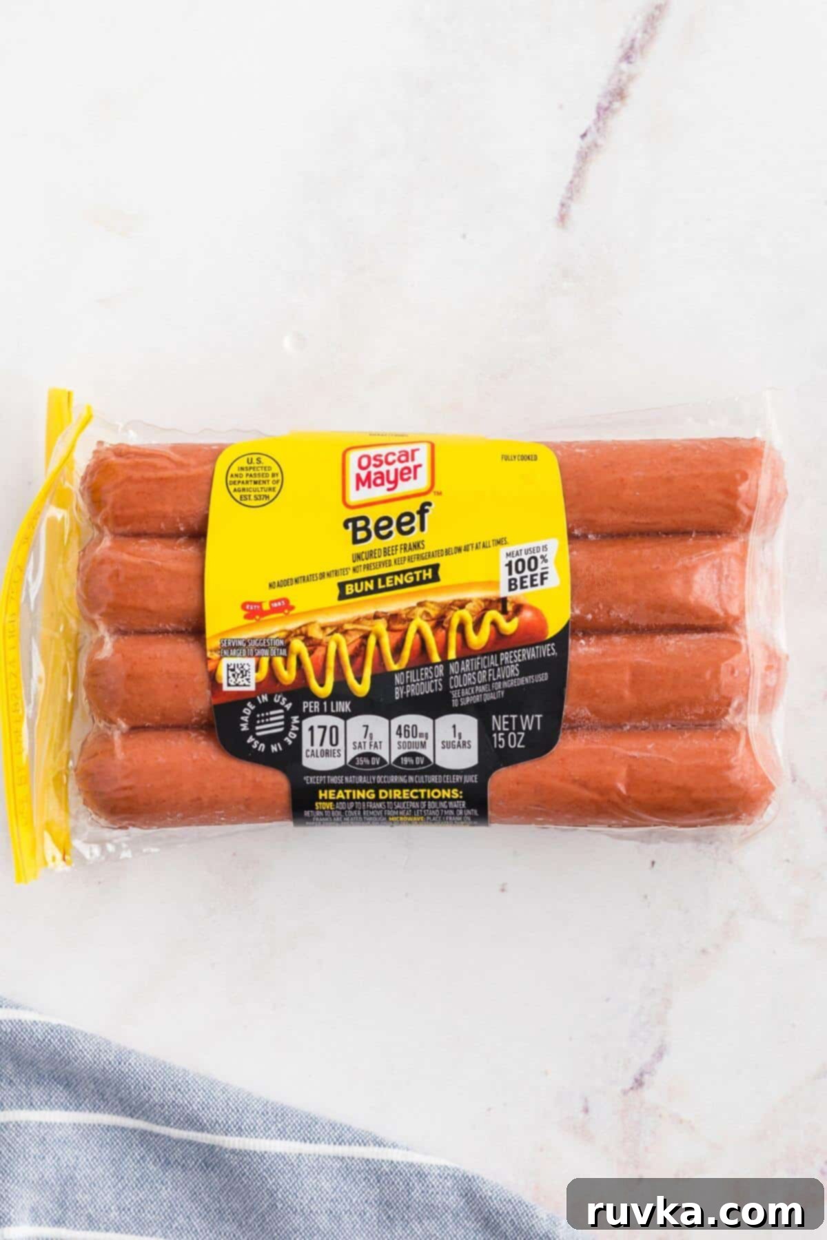 Easy Air Fryer Frozen Hot Dogs 3 One pack of oscar mayer frozen hot dogs on a marble table.