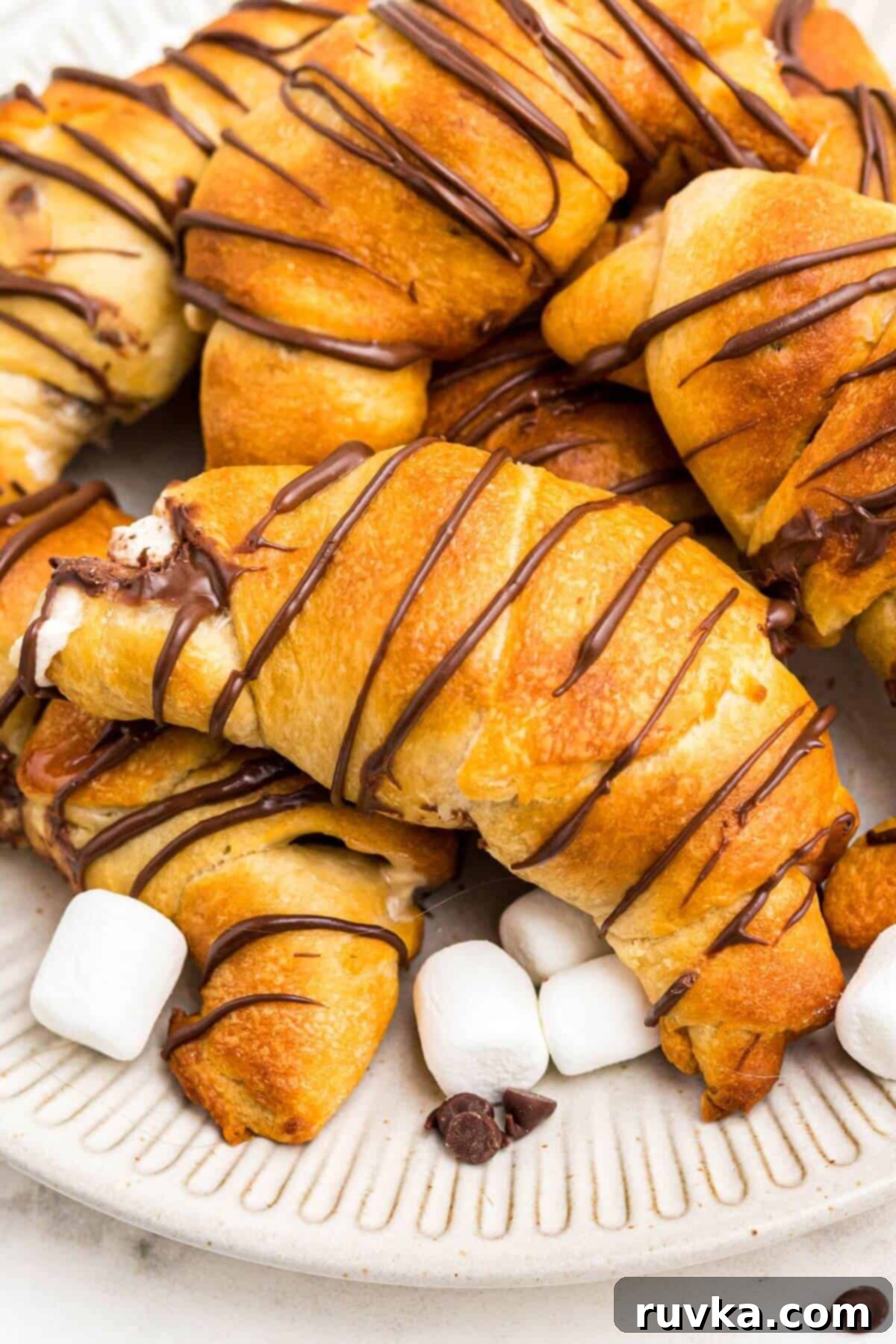 Air Fryer S'mores Crescent Rolls 8 Golden flaky crescent rolls filled with chocolate and marshmallows.