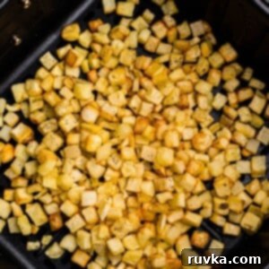 Crispy Air Fryer Frozen Potatoes 7 Golden and crispy cooked diced potatoes after being cooked and seasoned in the air fryer.