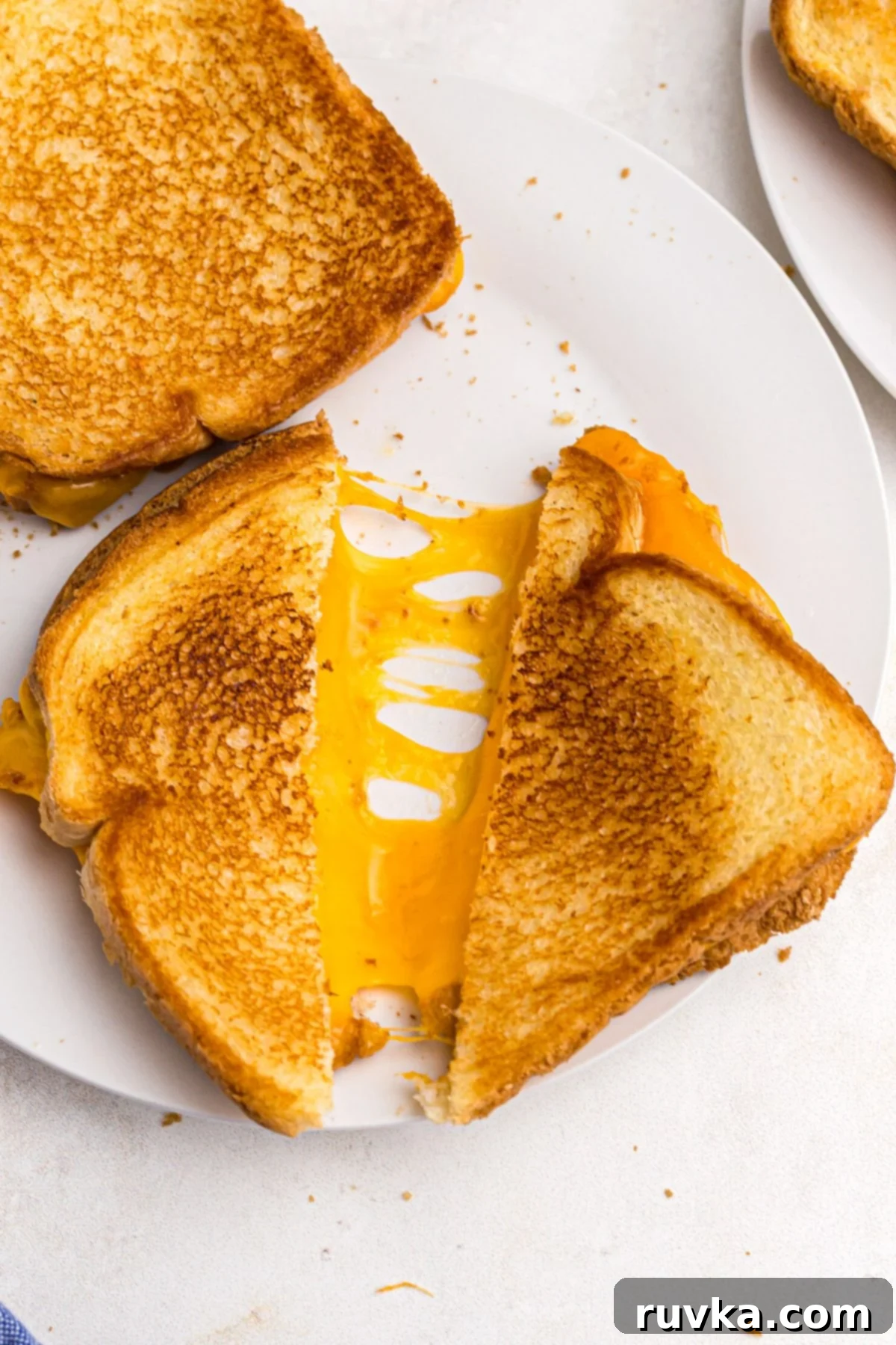 Golden and Gooey Air Fryer Grilled Cheese 7 Golden crispy slices of bread with melted cheese in the center.