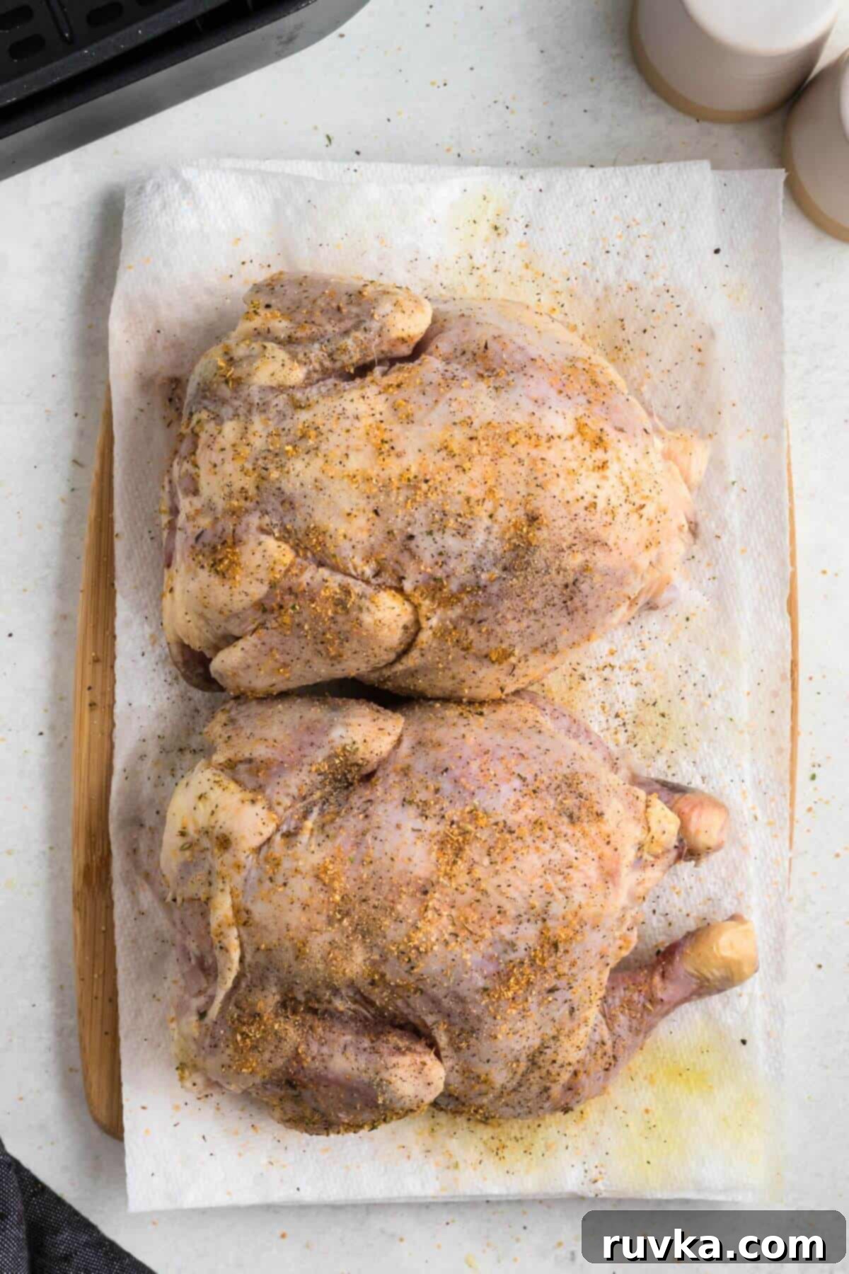 Crispy Air Fryer Cornish Game Hen 5 Seasoned Cornish hens on a paper towel before being cooked.