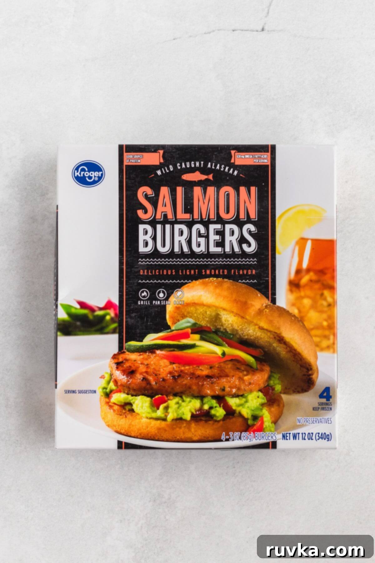 Crispy Air Fryer Frozen Salmon Burgers 3 Box of frozen salmon burgers on a white marble table.