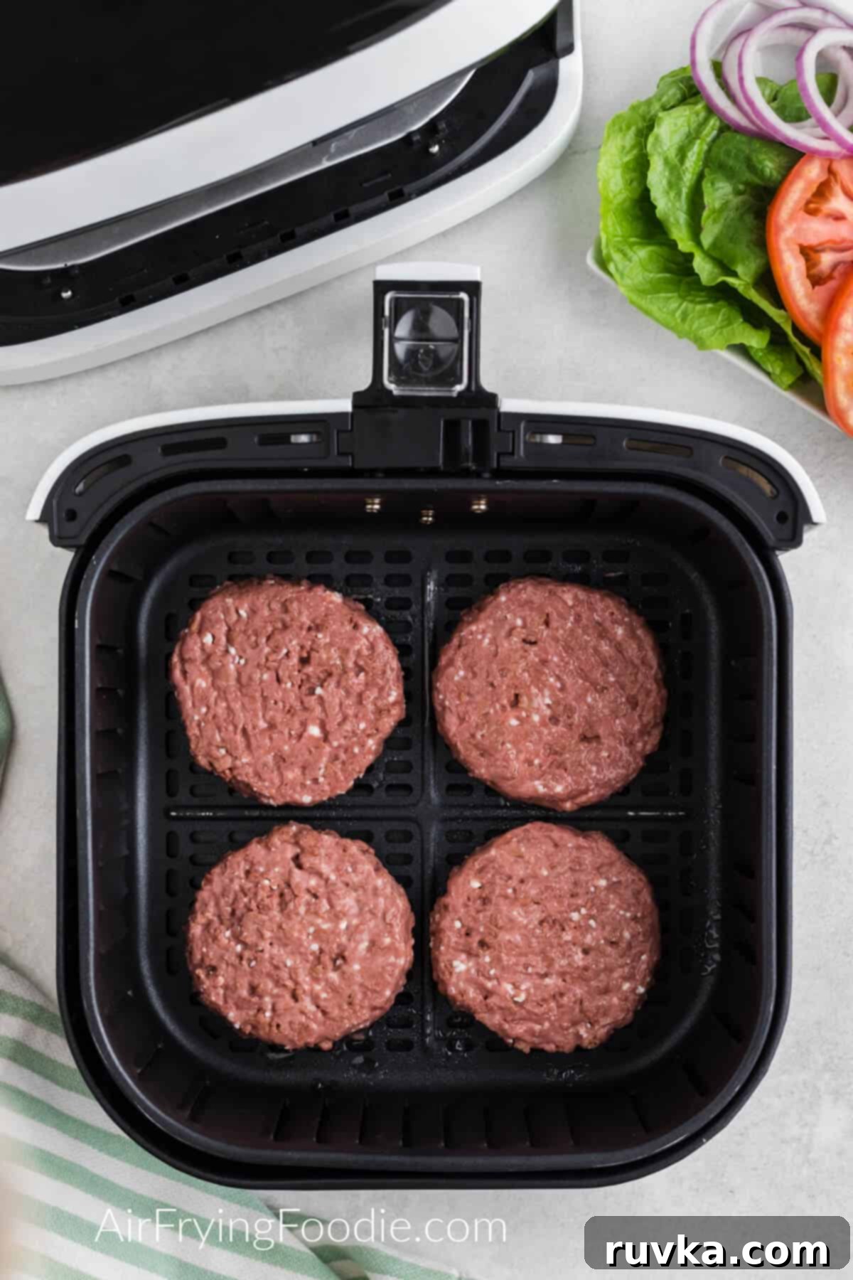 Easy Air Fryer Beyond Burger 5 Beyond burger in air fryer basket, ready to be air fried.