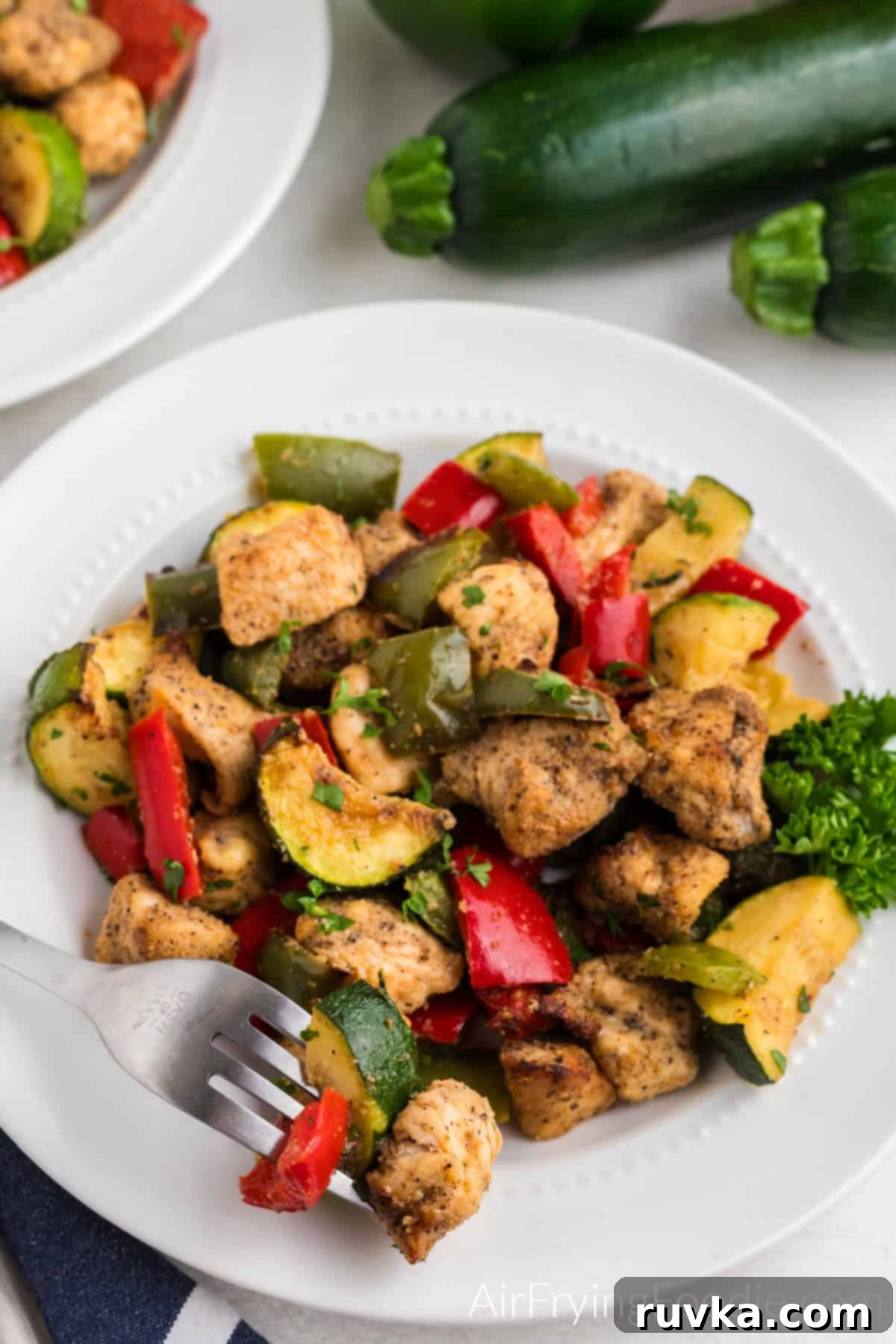 Crispy Air Fryer Chicken and Roasted Vegetables 6 air fried chicken and vegetables on a plate with a fork.