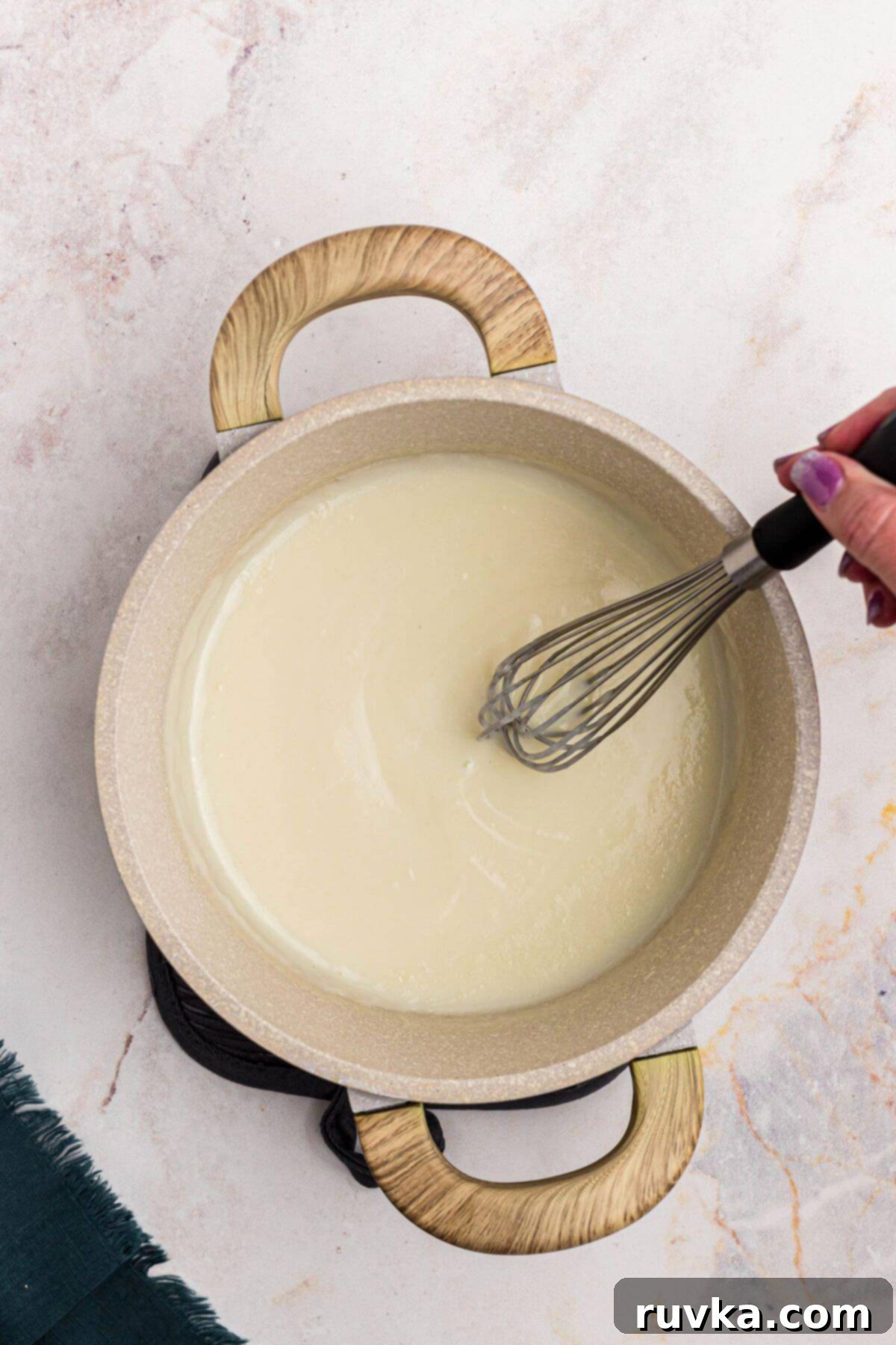 Creamy Cheese Sauce 5 Creamy sauce of butter, flour and milk mixed together in a saucepan.