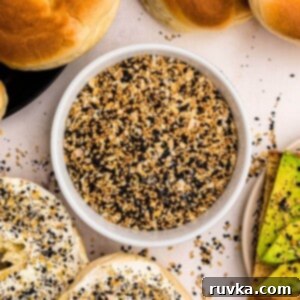 DIY Everything Bagel Seasoning 8 Everything Bagel Seasoning in a small bowl surrounded by bagels and avocado toast.
