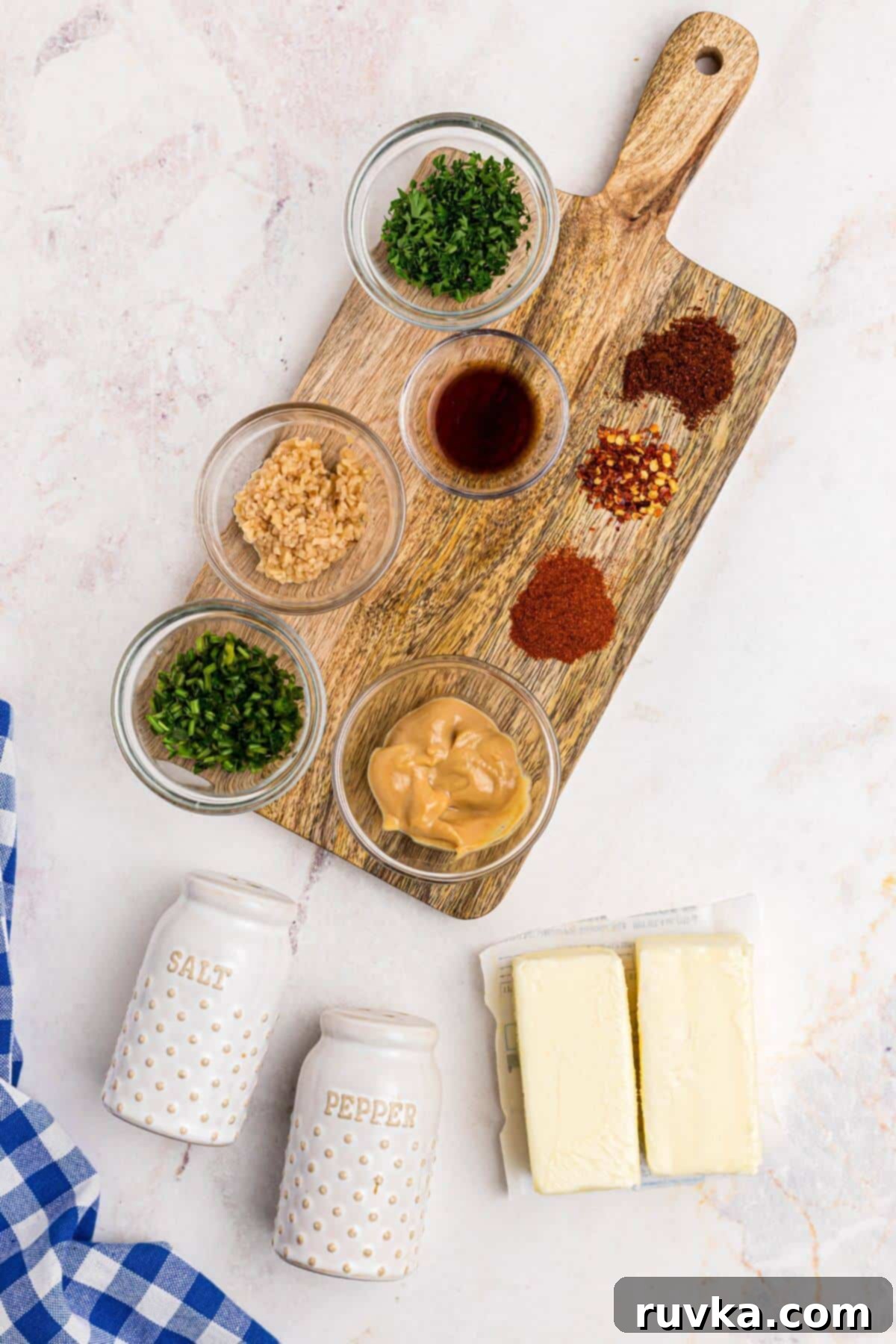 Robust Cowboy Butter 3 Seasonings and spices measured out with two sticks of butter on a marble table.