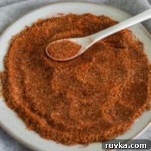 Master Your Own BBQ Rub 6 Homemade BBQ rub recipe to use on meats and vegetables, on a white plate.
