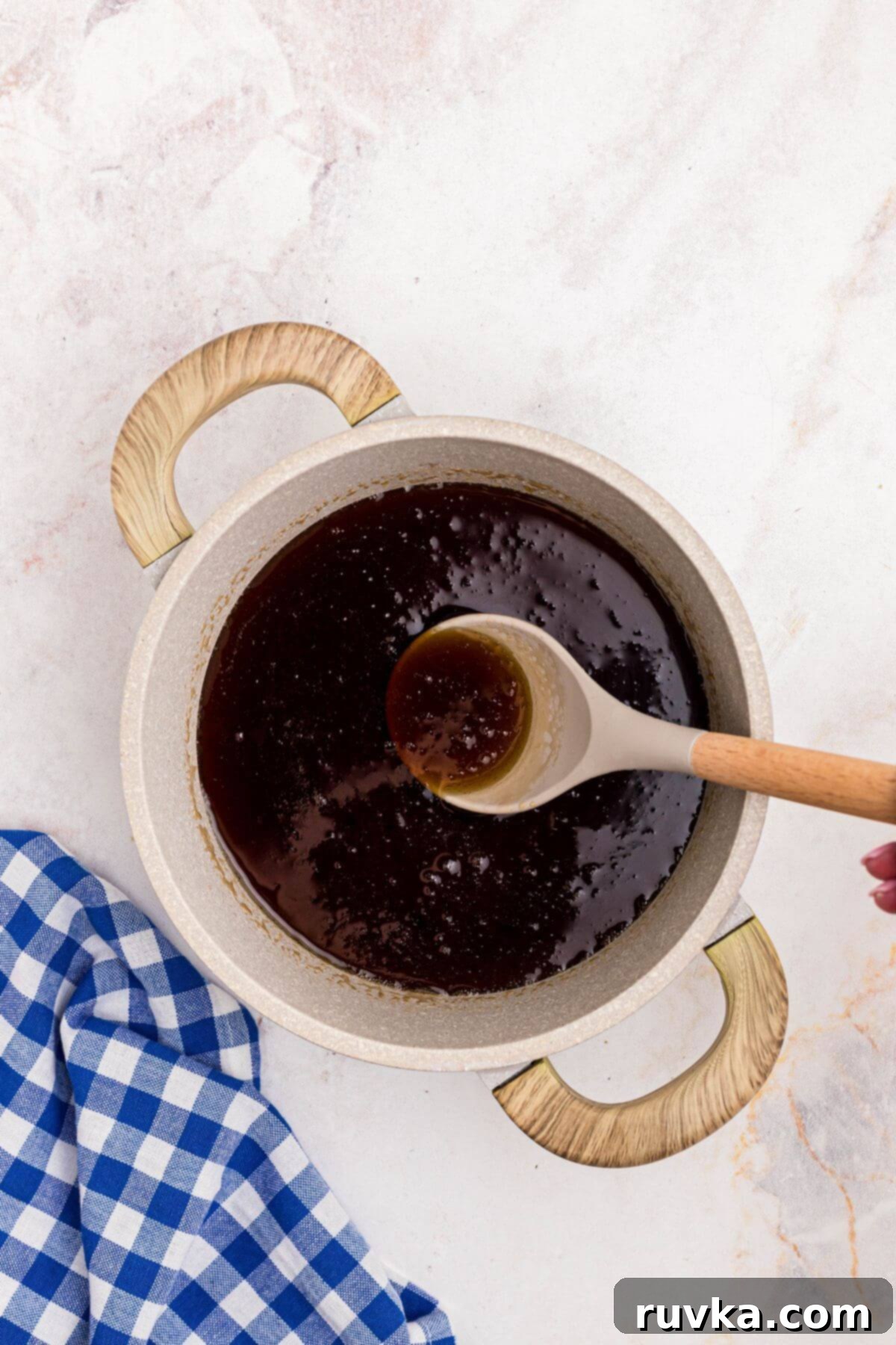 Easy Homemade Pancake Syrup 5 Sugars dissolved into water with maple extract in a medium saucepan making homemade syrup.