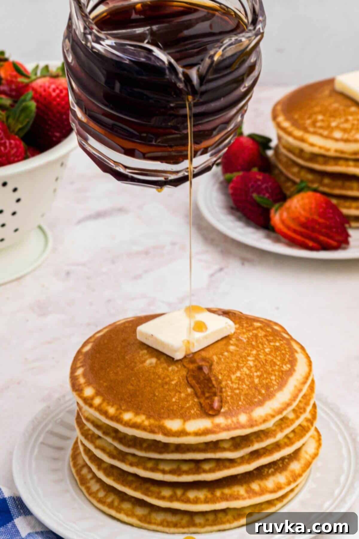 Easy Homemade Pancake Syrup 7 Syrup being poured over a stack of pancakes.