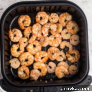 Point-Friendly Air Fryer Dishes 17 Garlic butter shrimp in the air fryer basket after being cooked.