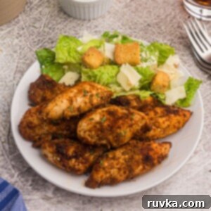 Point-Friendly Air Fryer Dishes 5 Blackened chicken served on a white plate with a salad.