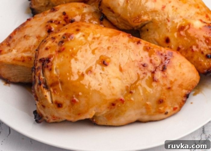 Golden Peach Air Fryer Chicken 8 Juicy and moist glazed chicken served on a white plate.