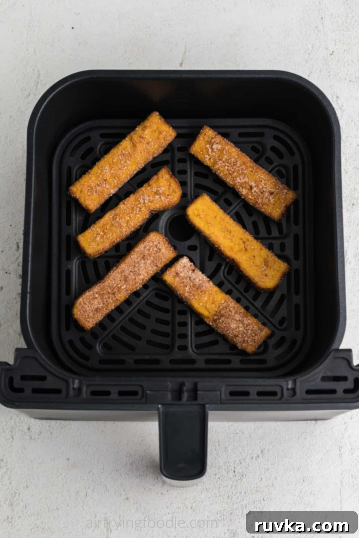 Crispy Air Fryer Frozen French Toast Sticks 4 Frozen french toast sticks in air fryer basket in a single layer. Ready to cook.