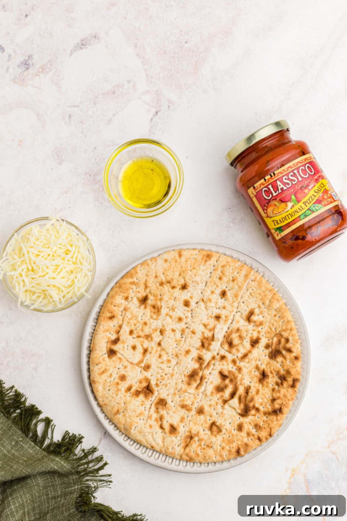 Crispy Air Fryer Pita Pizza 3 Ingredients needed to make air fryer pita pizza on a marble table.