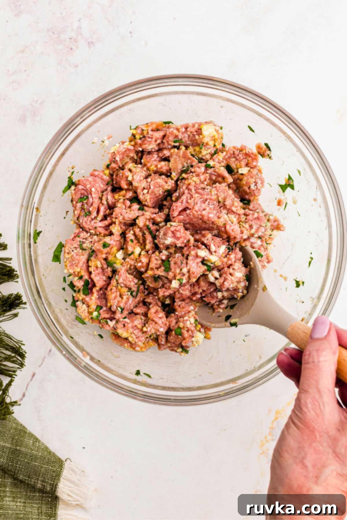 Crispy Air-Fried Greek Meatballs 4 Ground turkey mixed in a large glass bowl with seasonings and breadcrumbs.