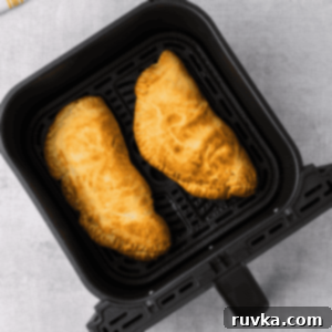 Air-Fried Calzone Pockets 10 Overhead shot of calzones in the air fryr basket.