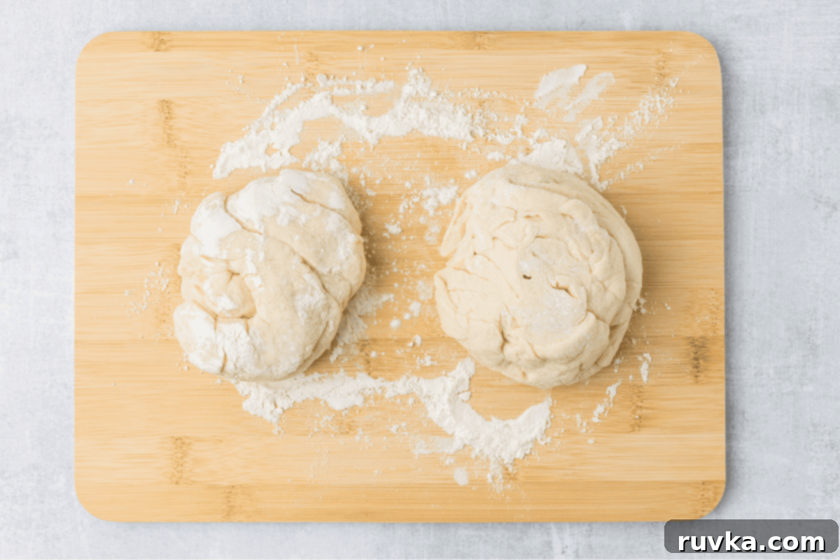 Air-Fried Calzone Pockets 4 dough divided into two on a cutting board.