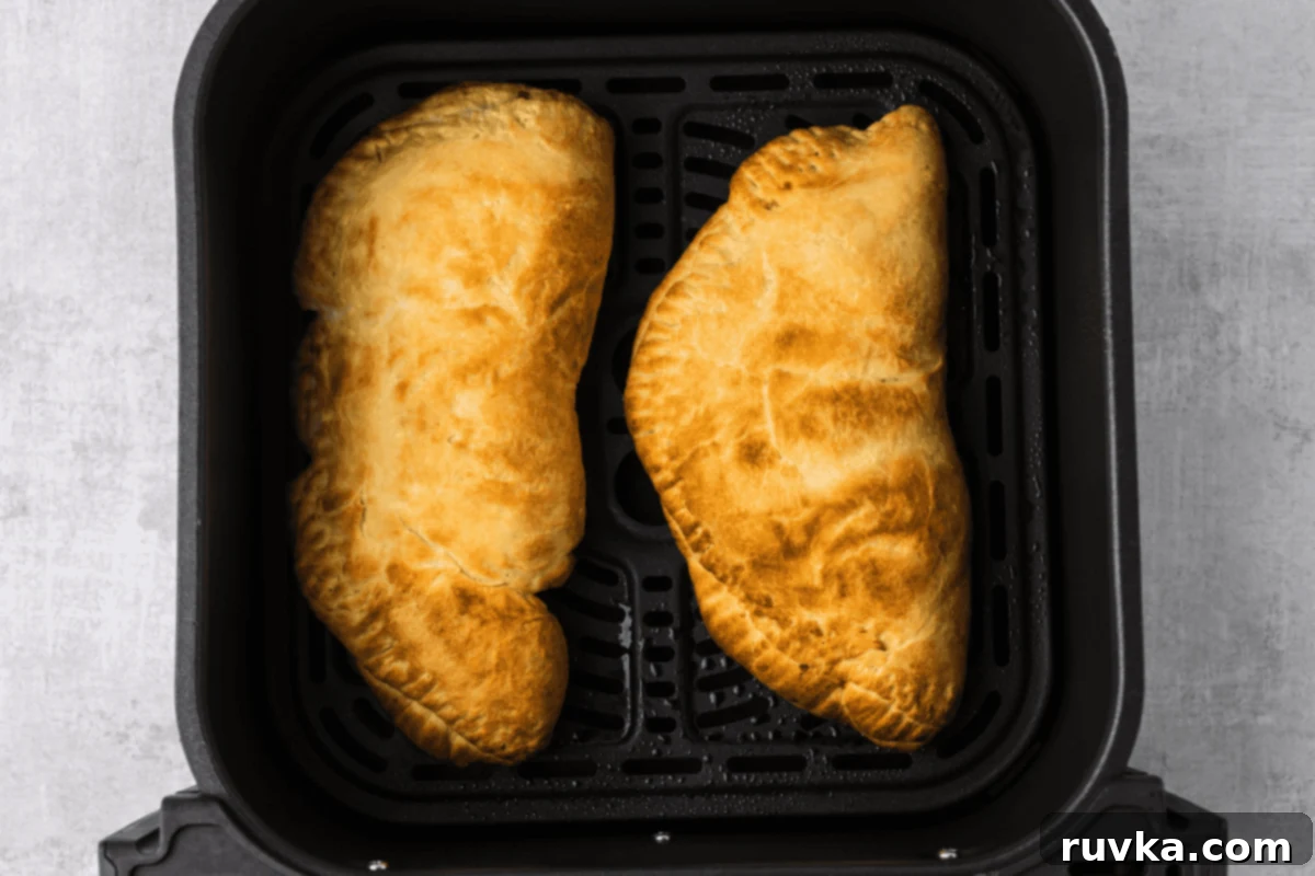 Air-Fried Calzone Pockets 7 Calzones in the air fryer basket, fully cooked.
