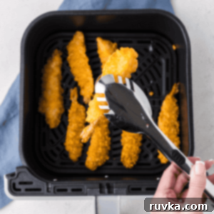 Crispy Air Fryer Frozen Shrimp Tempura 8 Fully cooked, crispy frozen shrimp tempura in an air fryer basket, ready to serve.
