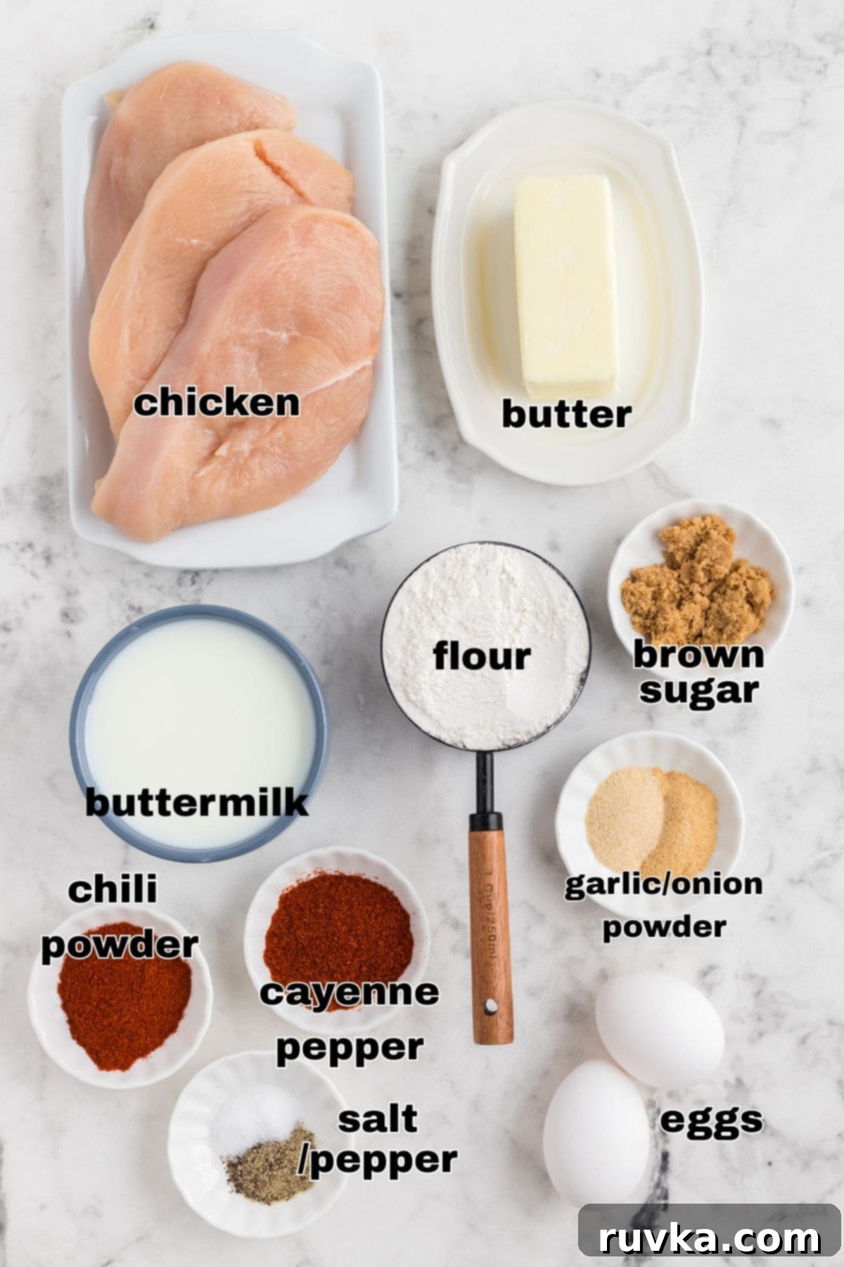 Crispy Air Fryer Nashville Hot Chicken 3 Ingredients needed to make Nashville Hot Chicken measured in small bowls on a marble table.