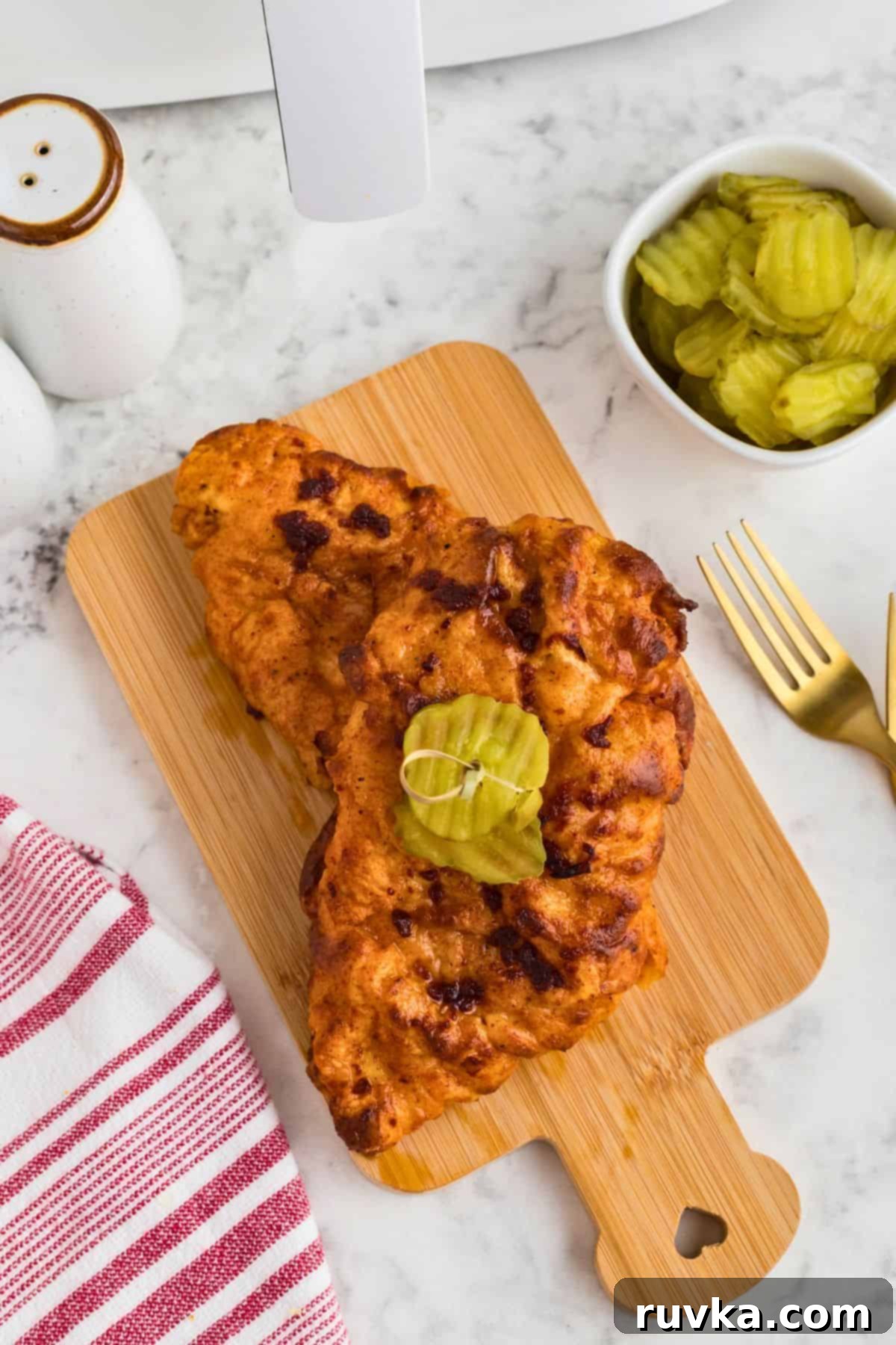 Crispy Air Fryer Nashville Hot Chicken 9 Air fryer Nashville Hot Chicken on a white plate.