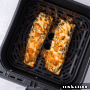 Crispy Air-Fried Pesto Parmesan Salmon 12 Close up of cheesy air fryer pesto salmon in the basket of the air fryer.