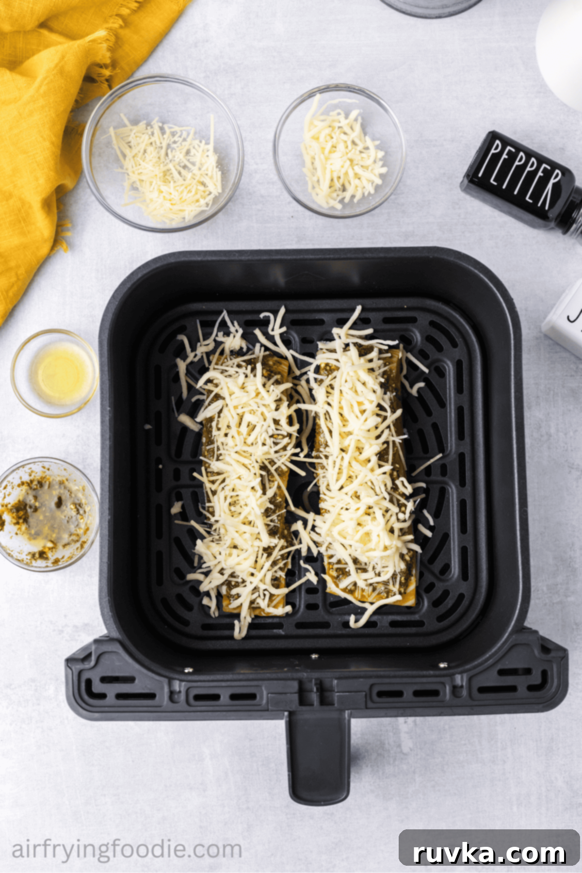 Crispy Air-Fried Pesto Parmesan Salmon 7 Salmon fillets in air fryer basket, perfectly topped with vibrant pesto and a generous sprinkle of cheese.