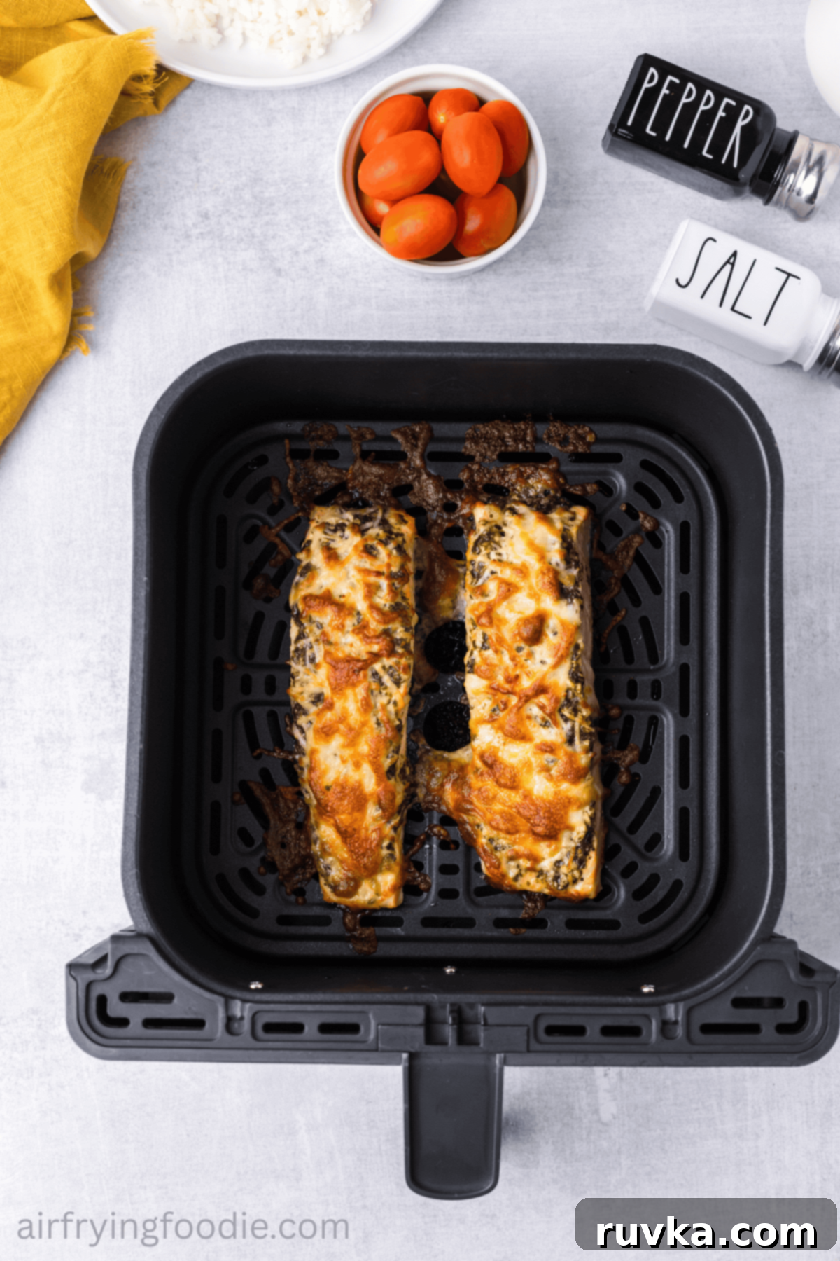 Crispy Air-Fried Pesto Parmesan Salmon 8 Golden, cheesy pesto salmon cooking in the air fryer basket, showing the bubbling cheese crust.