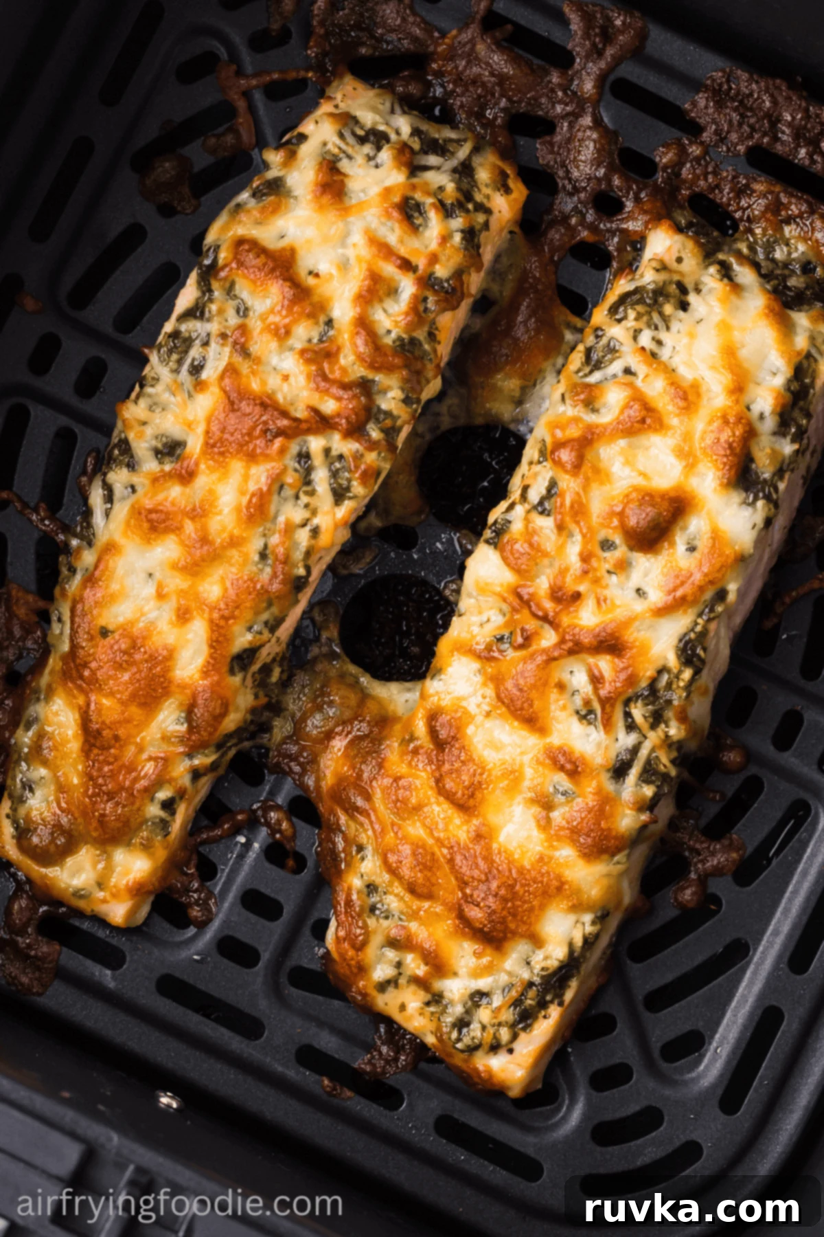 Crispy Air-Fried Pesto Parmesan Salmon 10 Close-up of golden, cheesy pesto salmon in the air fryer basket, showing its crispy top.