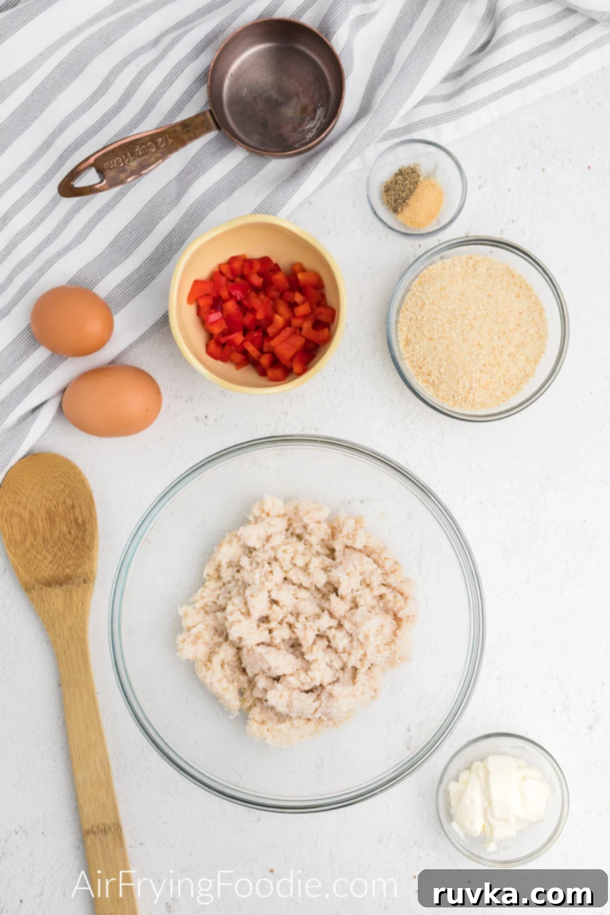 Crispy Air Fryer Crab Cakes 3 Ingredients needed to make crab cakes in the air fryer, including lump crab meat, eggs, mayonnaise, bell pepper, breadcrumbs, and seasonings.