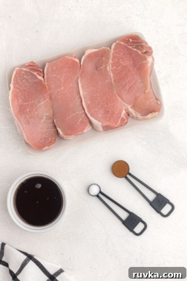 Juicy Air Fryer Maple Glazed Pork Chops 4 Ingredients to make maple glazed pork chops on a white table
