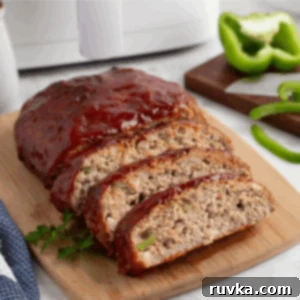 Sliced turkey meatloaf on a cutting board.