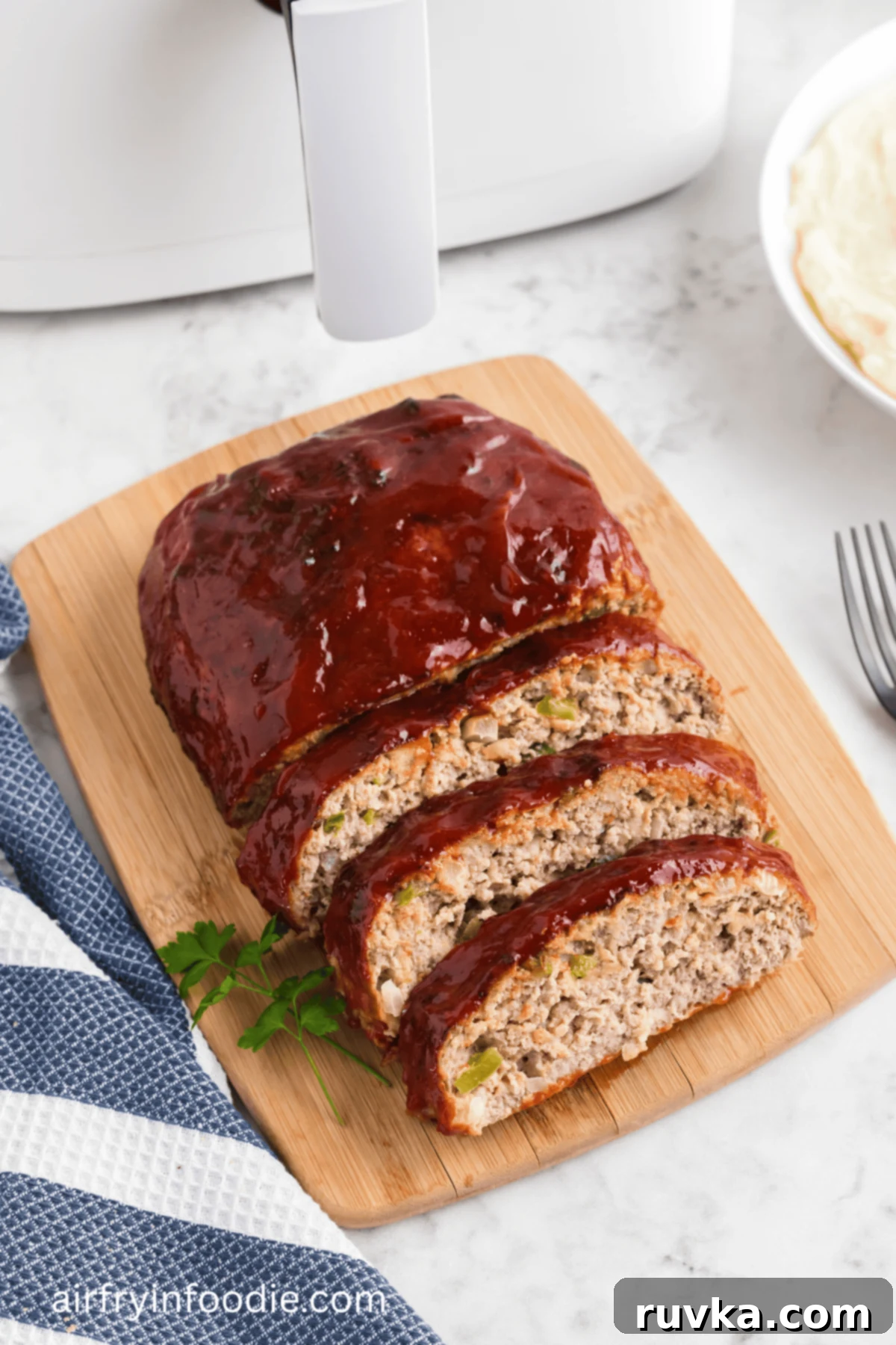 Air fryer turkey meatloaf on a cutting board, sliced and ready to serve.